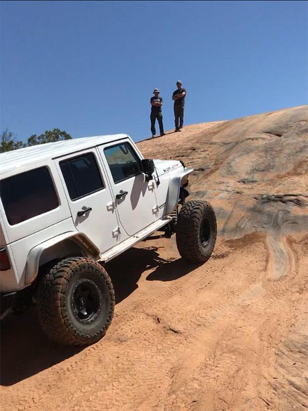 White Jeep® Wrangler Climbing Rock Face